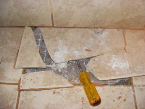 Angle Screwdriver at a 45° Angle to Force Up the Cracked Tile
