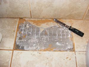 Carefully Remove Grout Where Tiles Meet at a Corner